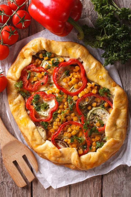 Rustic vegetable pie on a table close-up and ingredients. vertical top view\, stock photo
