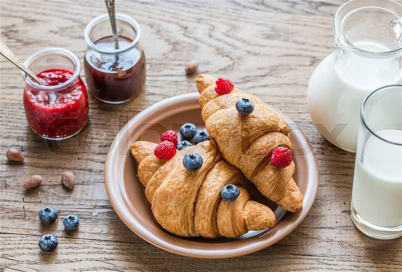 Croissants with fresh berries and jam, stock photo