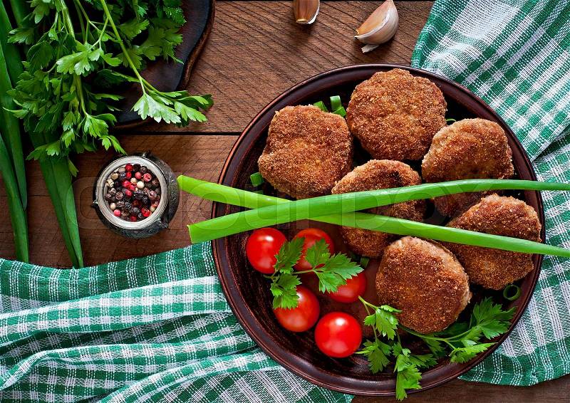 Juicy delicious meat cutlets on a wooden table in a rustic style, stock photo