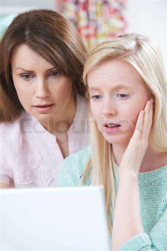 Mother Comforting Daughter Victimized By Online Bullying, stock photo