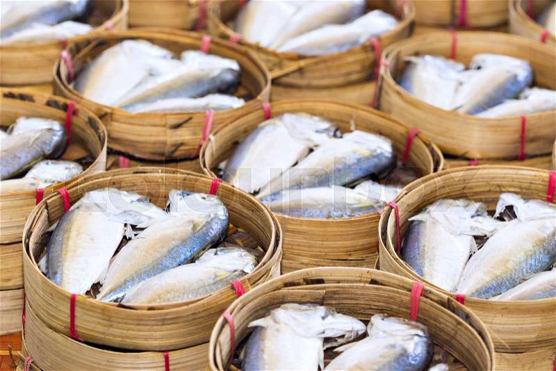 Steamed fish, Plaa Tuu (mackerel) in bamboo steamers at the seafood market in Thailand, stock photo