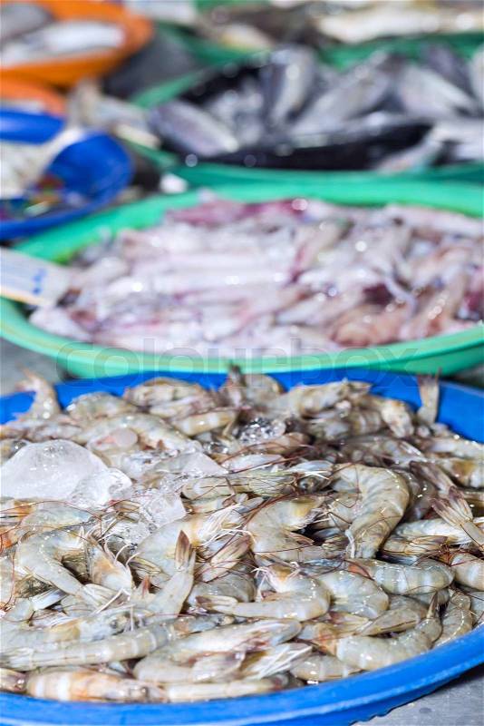Fresh shrimps on ice exposition at the seafood market In Thailand. Display of tiger prawns catch of the day, stock photo