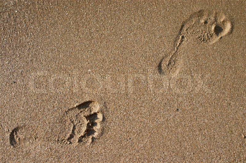 Human footprint on sea sand beach, stock photo