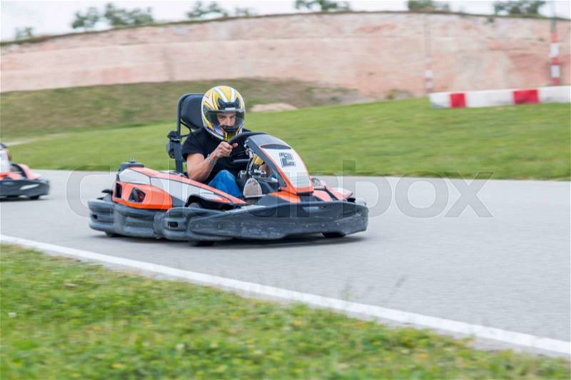 Young man driving a kart in a race, stock photo