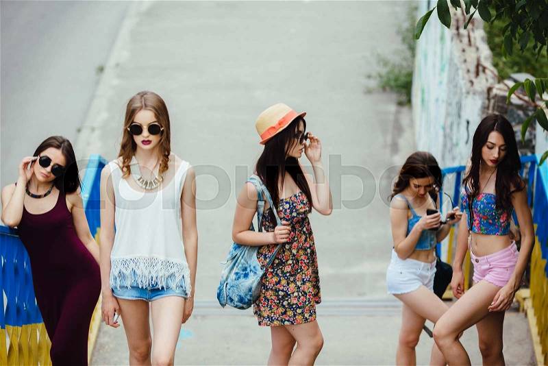 Five young beautiful girls walking and having fun in the city, stock photo