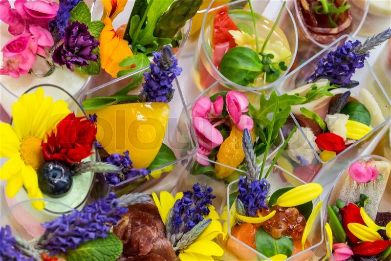 Canaps with edible flowers meat cheese and seafood, stock photo