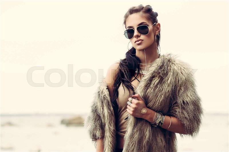 Portrait of a beautiful lady with flash tottoos posing outdoors near the sea, stock photo