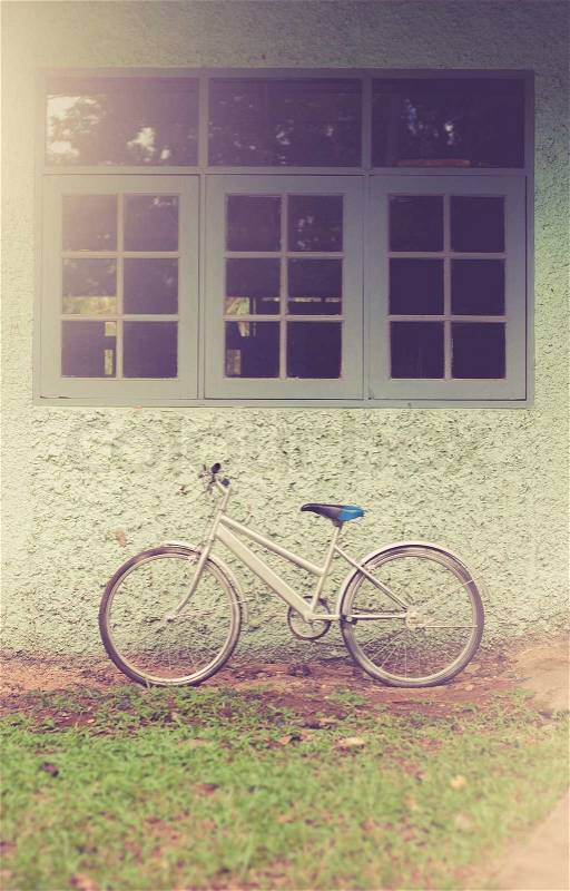 Vintage bike against wall,vintage tone style, stock photo