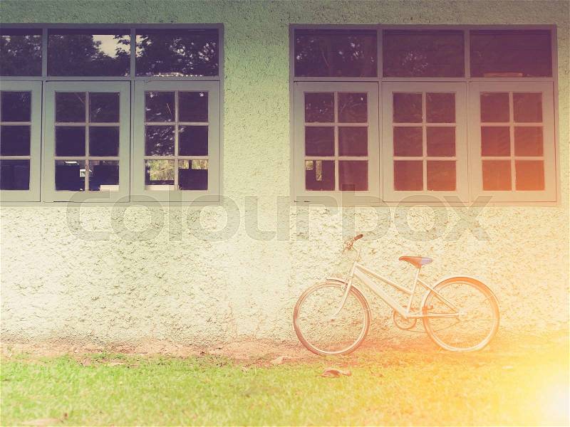 Vintage bike against wall,vintage tone style, stock photo