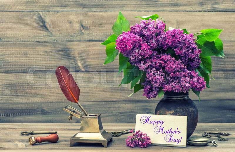 Still life with lilac flowers and antique accessories. Vintage style toned photo. Sample text Happy Mother\'s Day!, stock photo