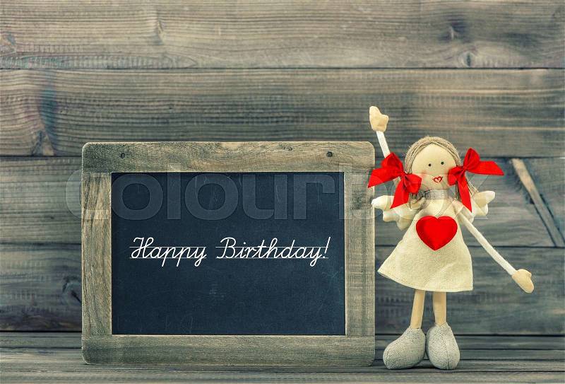Cute doll with Red Heart. Lovely Birthday decoration. Holidays card concept. Vintage style toned picture, stock photo