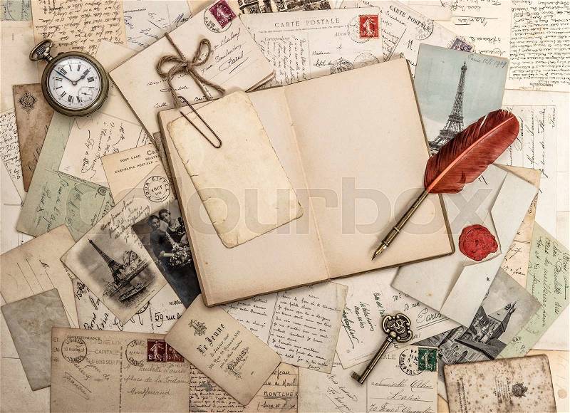 Open diary book, old accessories and postcards. Sentimental vintage style background, stock photo