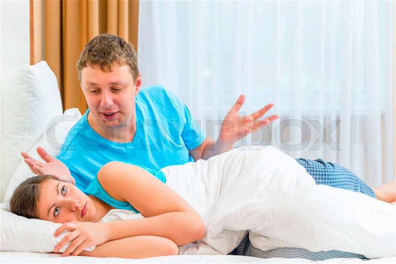 Couples quarrel in the morning in bed, stock photo