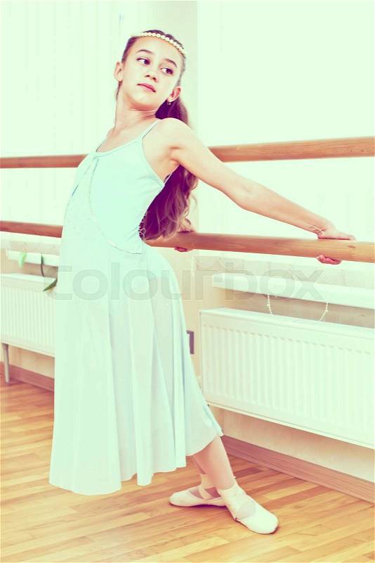 A little girl dressed as a ballerina in ballet, stock photo
