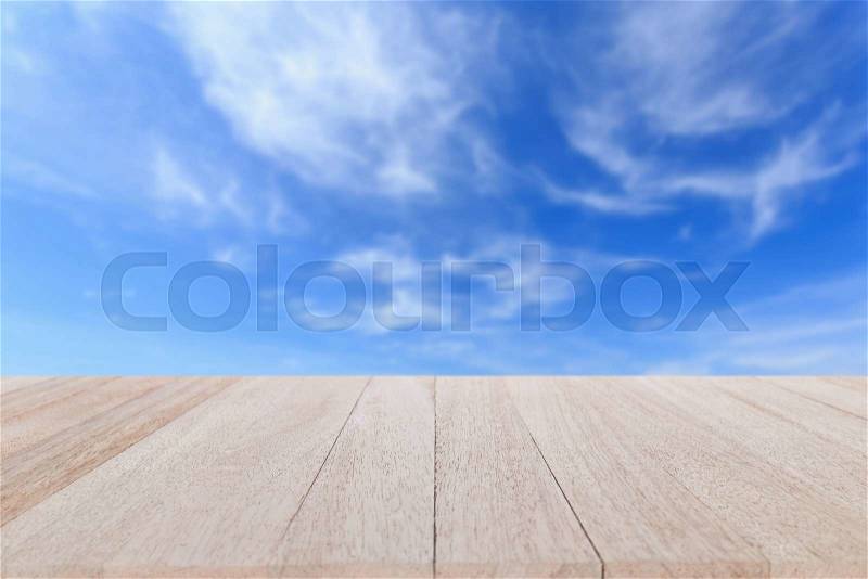 Close up top wooden table and blur of blue sky background, stock photo