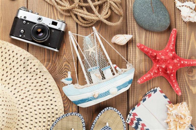 Travel and vacation items on wooden table. Top view, stock photo