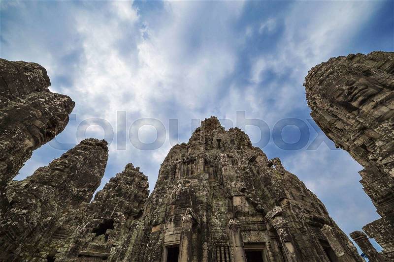 Ancient stone faces of king Jayavarman VII at The Bayon temple, Angkor, Cambodia , stock photo