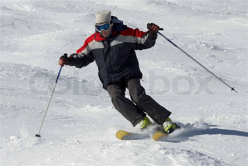 Skier moving down on the snow hill, stock photo