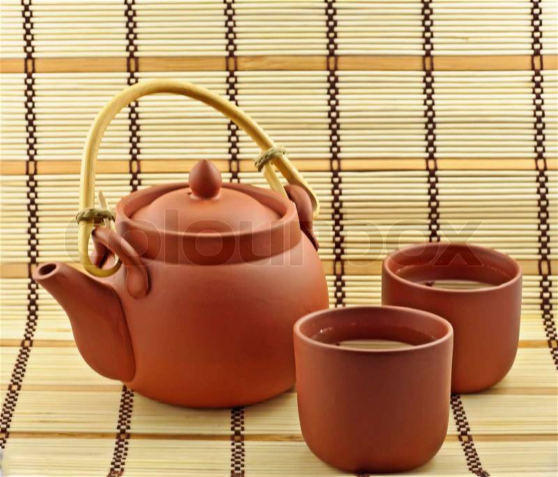 Clay set from two cups and teapot with green tea, stock photo