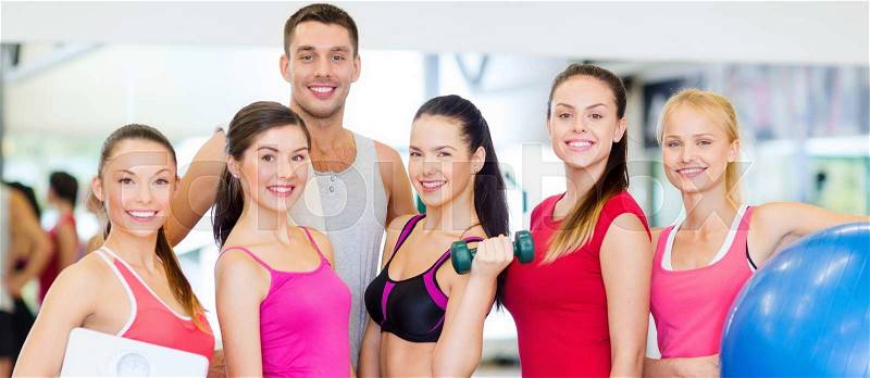 Fitness, sport, training, gym and lifestyle concept - group of smiling people in the gym, stock photo
