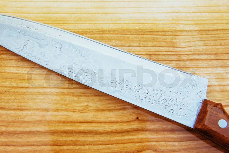 Knife on an wooden cutting board, stock photo