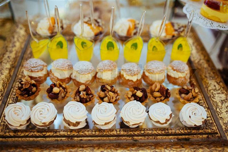 Many servings of sweet tasty dessert on buffet, stock photo