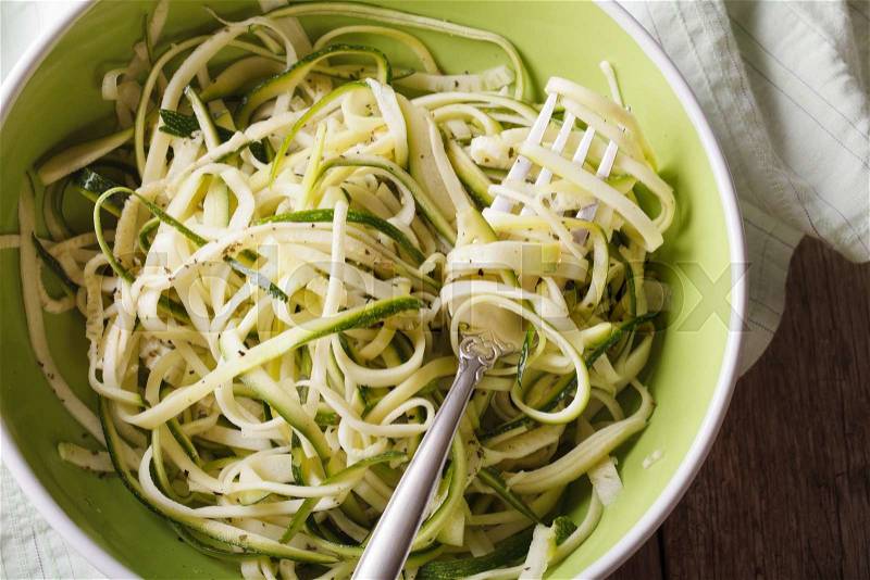 Dietary zucchini pasta in a bowl closeup on the table. horizontal view from above , stock photo