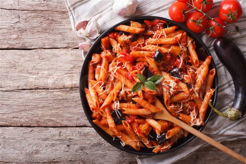 Italian food: Pasta alla Norma close-up on the table and ingredients. horizontal top view , stock photo