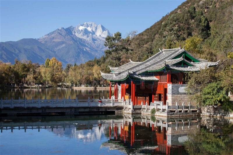 Lijiang old town scene-Black Dragon Pool Park. . In the there, you can see Jade Dragon Snow Mountain, stock photo