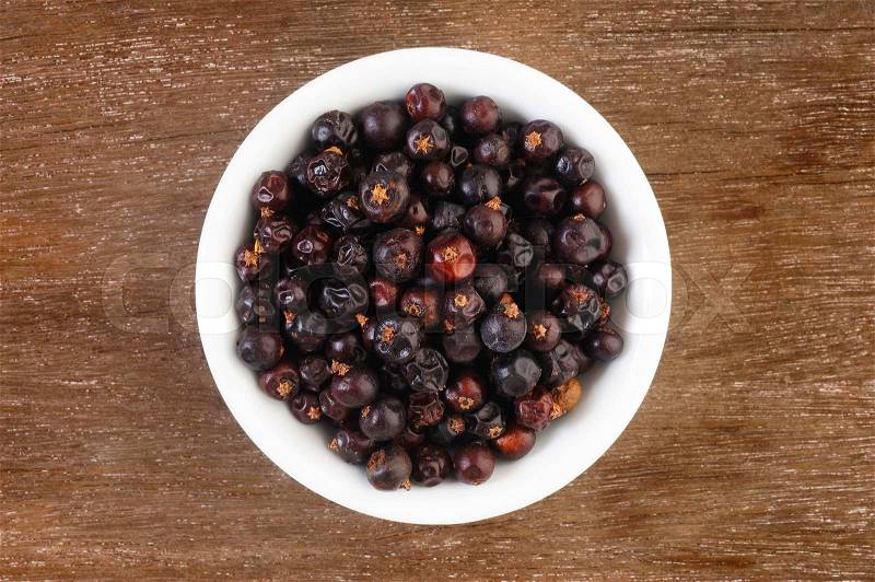 Juniper berries in white bowl, stock photo