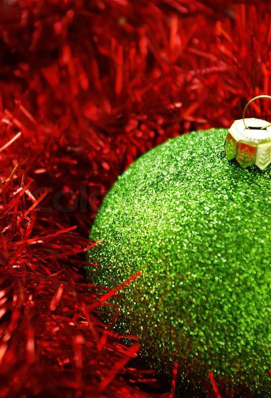 Cristmas holiday decor with green sphere and red tinsel, stock photo