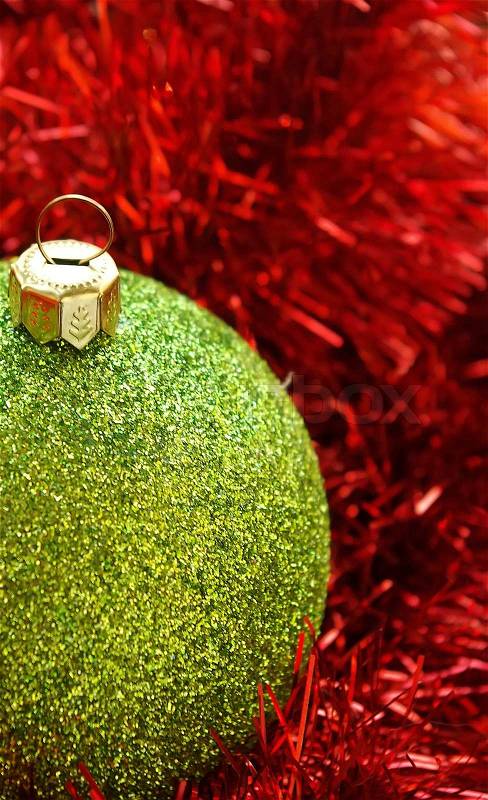 Christmas holiday decor with green sphere and red tinsel, stock photo