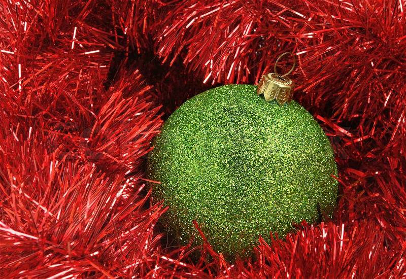 Cristmas holiday decor with green sphere and red tinsel, stock photo