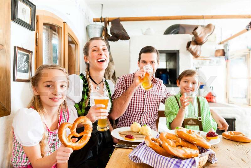Bavarian family having traditional meal in German restaurant , stock photo