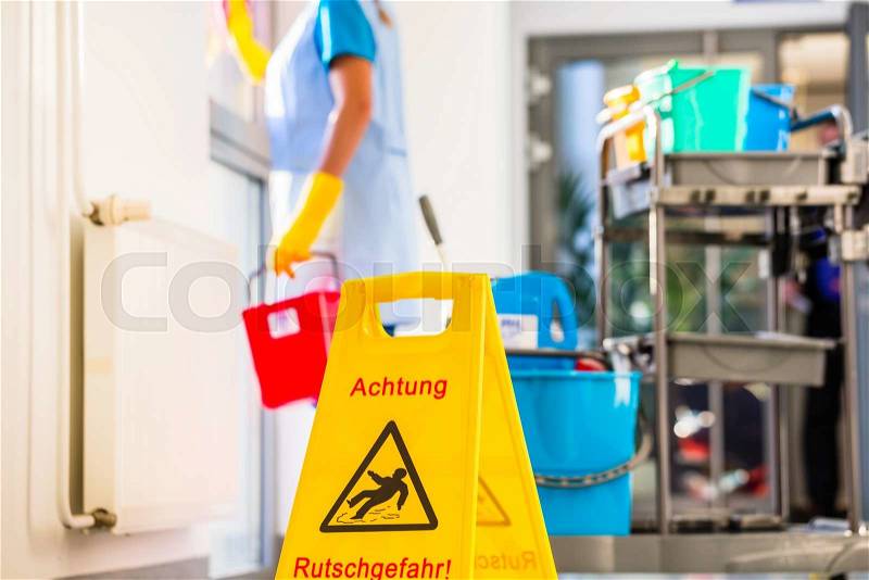 Warning sign on floor in cleaning operation, stock photo