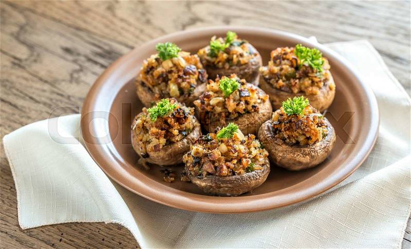 Mushrooms\' caps stuffed with mixture of cheese, onion, breadcrumbs and butter, stock photo