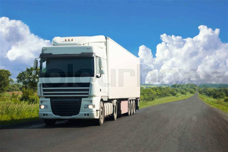 White truck moving on a road in summer, stock photo