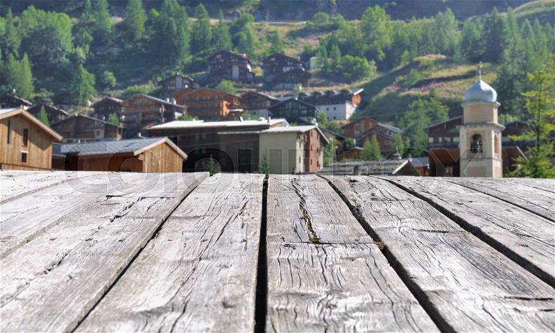 Savoy village bordering the boards of a wooden bridge, stock photo