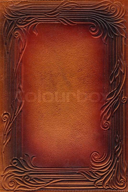 Brown and red leathercraft tooled vintage book cover with texture and border, stock photo