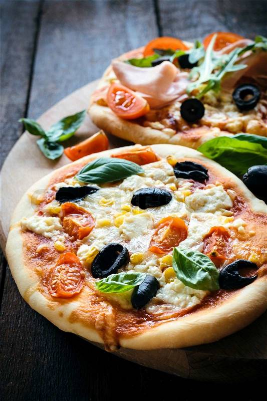 Vegetarian mini pizza served on wooden board,selective focus , stock photo