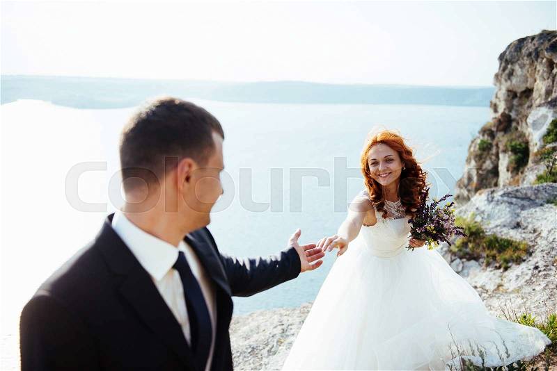Wedding couple staying over beautiful landscape, stock photo