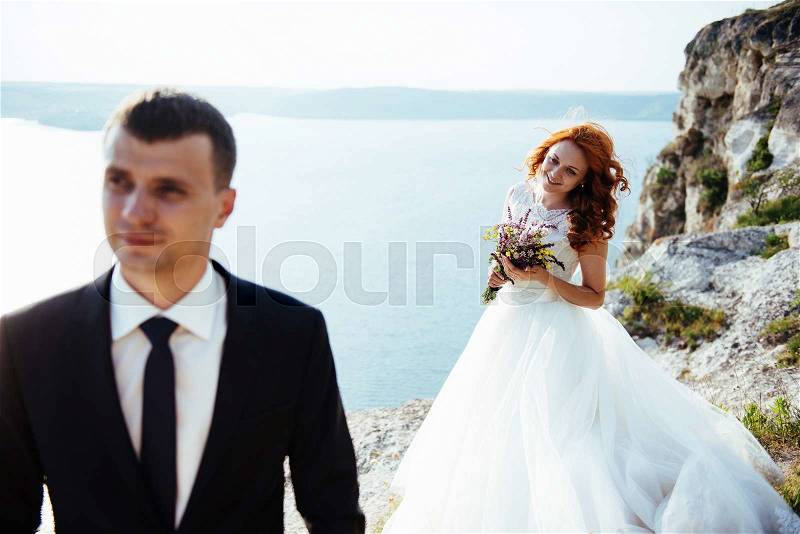 Wedding couple staying over beautiful landscape, stock photo