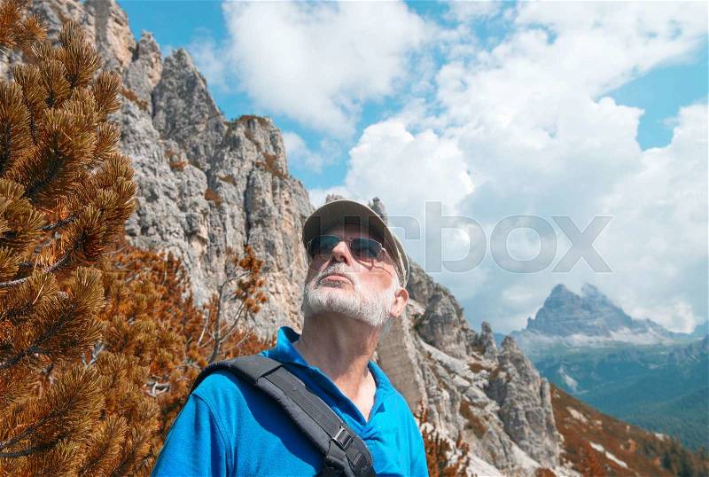 Mountaineer looking at the mountains. Trekking and adventure concept, stock photo
