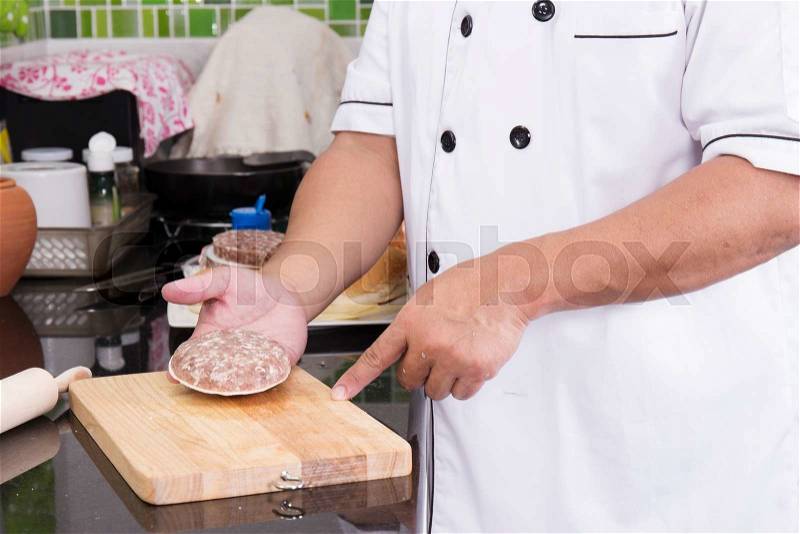 Chef present Hamburger patty brfore cooking / cooking Hamburger concept, stock photo