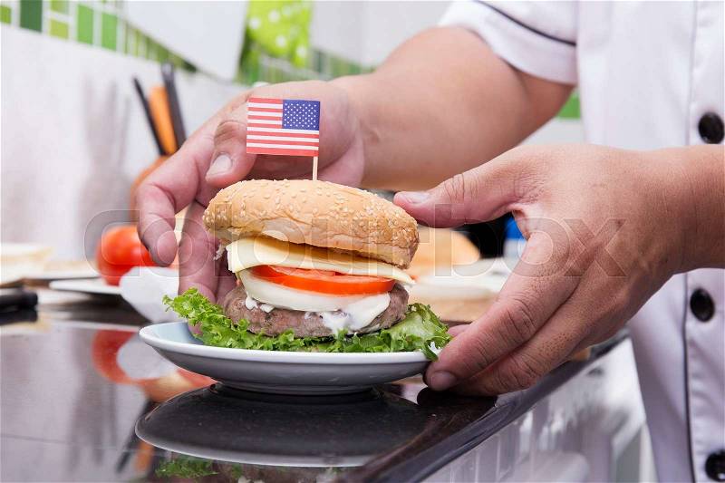Chef cooking and decorated Hamburger with American Flag /Cooking Hamburger concept, stock photo