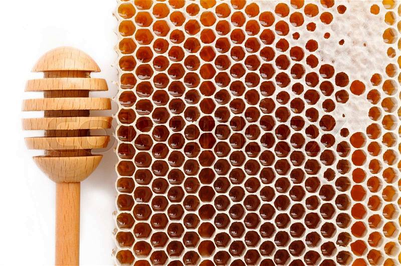 Honeycomb and wooden stick on white background, stock photo