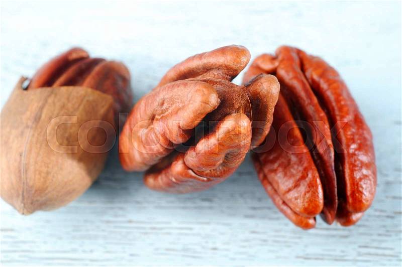 Pecan nuts on wooden background, stock photo