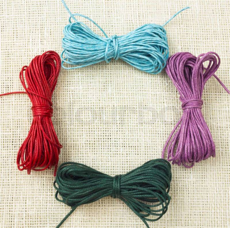 Set of colorful ropes on white canvas. handcraft concept decorative frame, stock photo