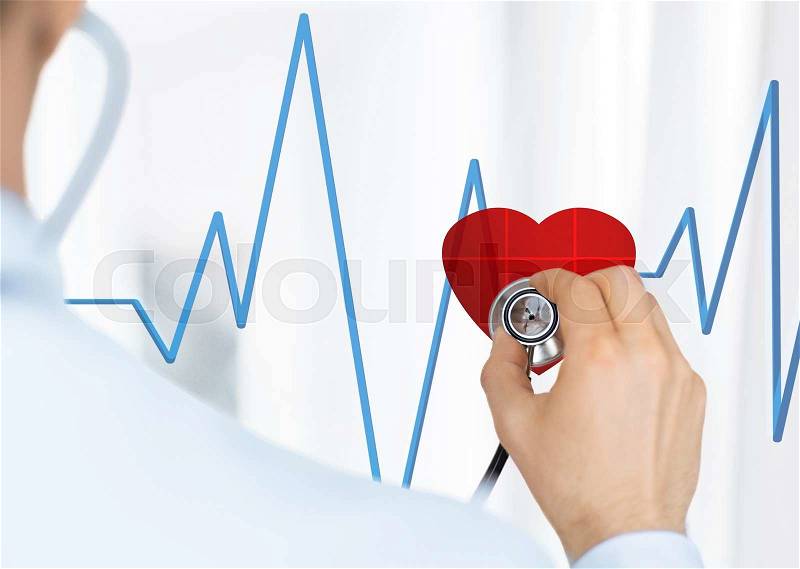 Doctor with stethoscope listening heart beat on virtual screen, stock photo