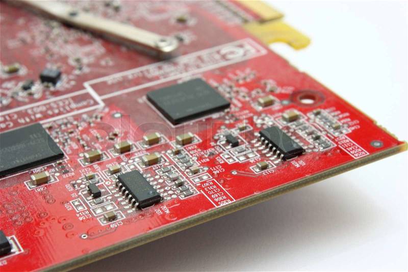 Electronic payment of a video card of red color with radio components and microcircuits, stock photo